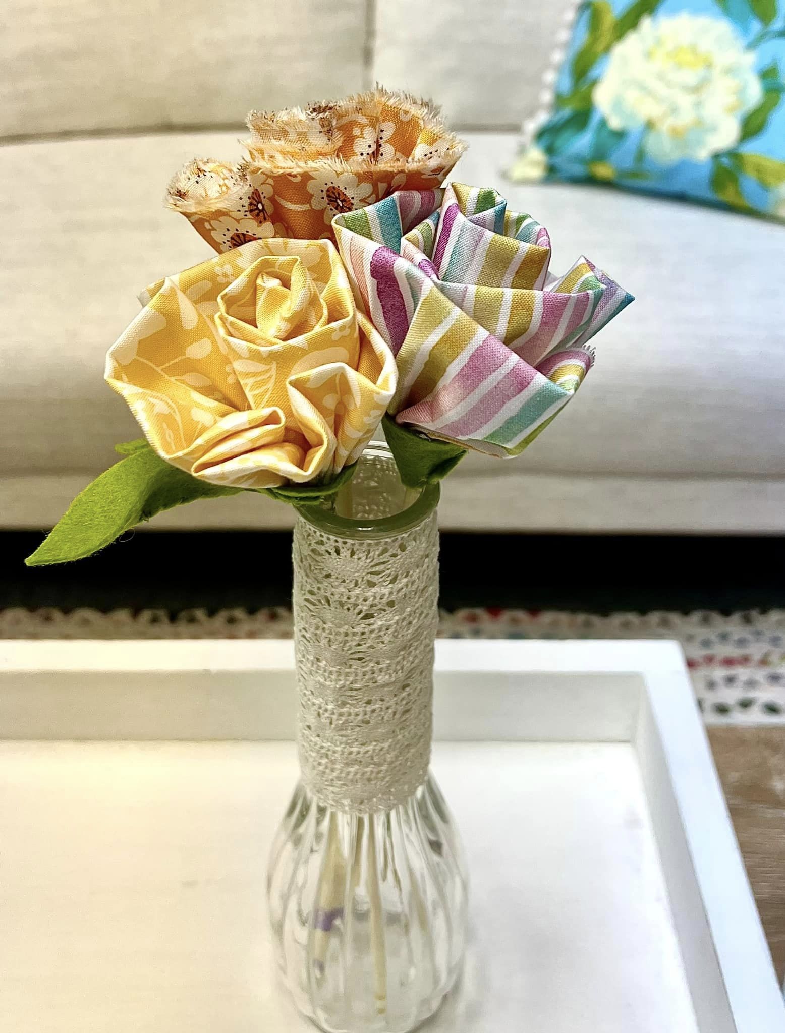 fabric flowers in a vase on a coffee table