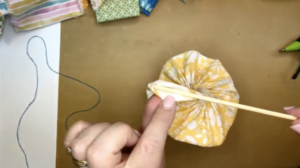 using a skewer to get fabric flower together
