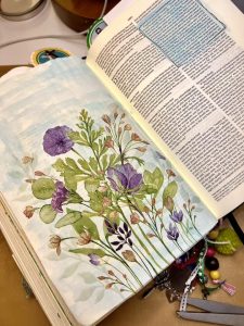 bible with purple flowers in it 