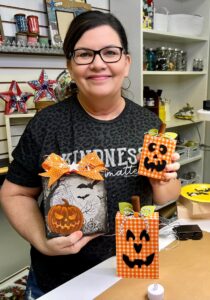 Tracy holding Halloween decor that she created 