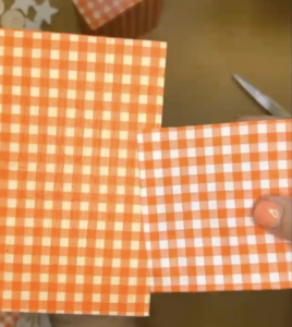 wooden block with white and orange gingham napkin on top 